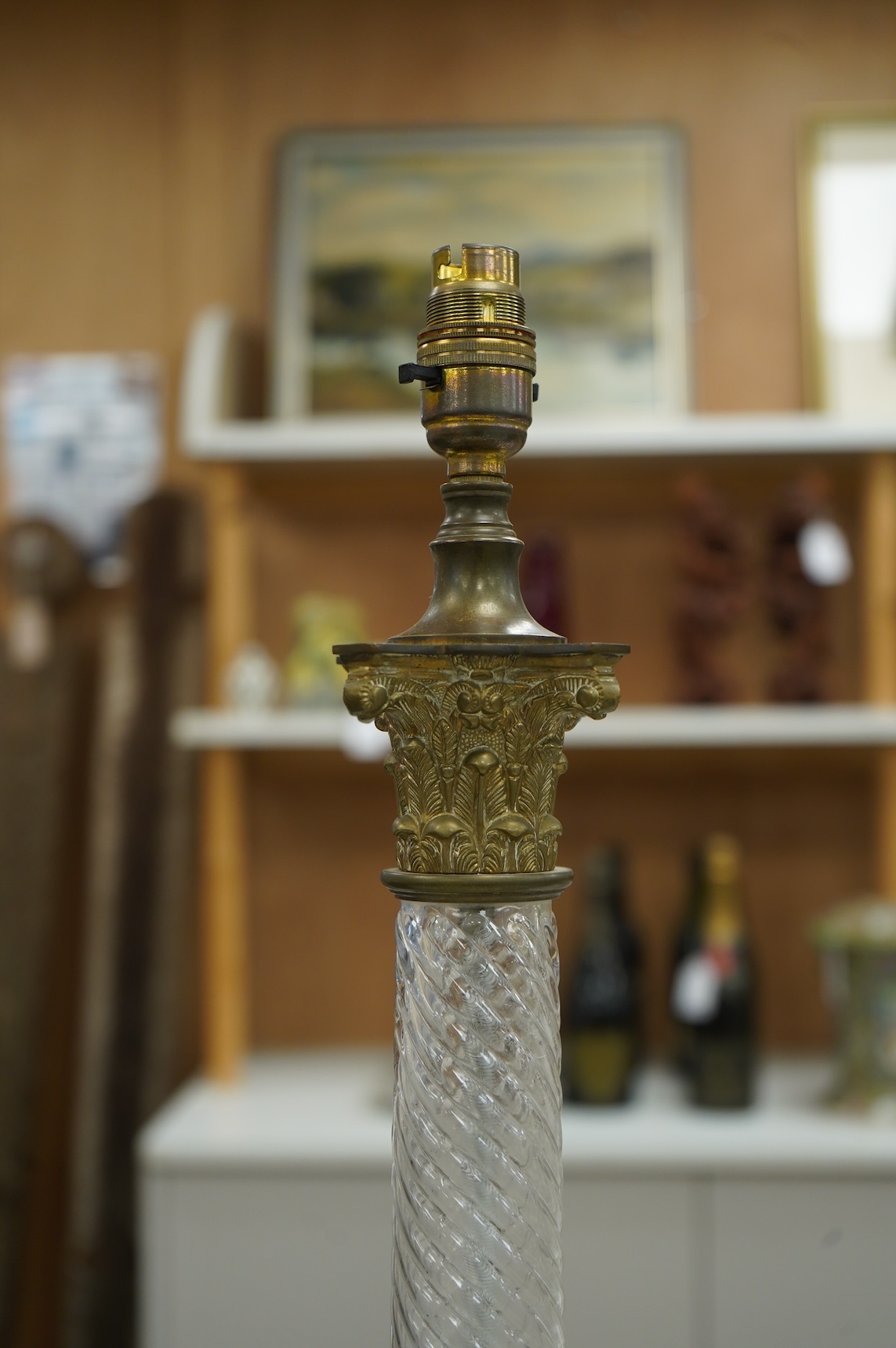 A pair of brass and glass Corinthian column lamps, 59cm high overall